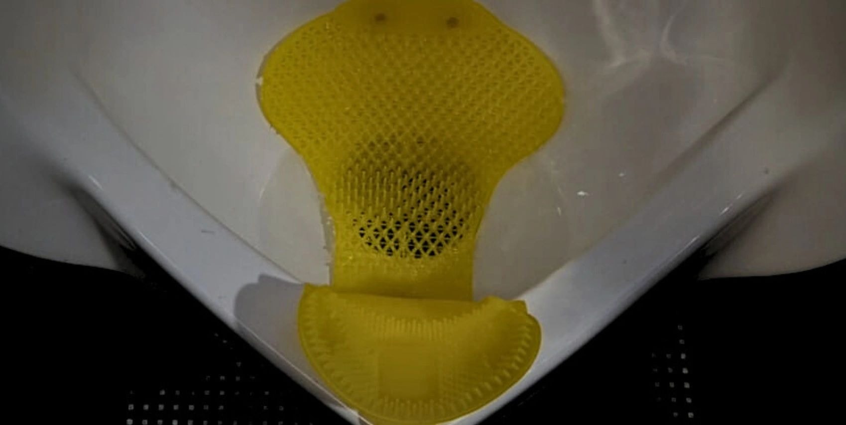 U-R-IN® circular urinal screen showing anti-splash projections, airflow sections, and drip-catching lip